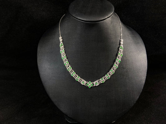 A necklace set with vibrant green jadeite cabochons.