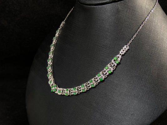 A necklace set with vibrant green jadeite cabochons.