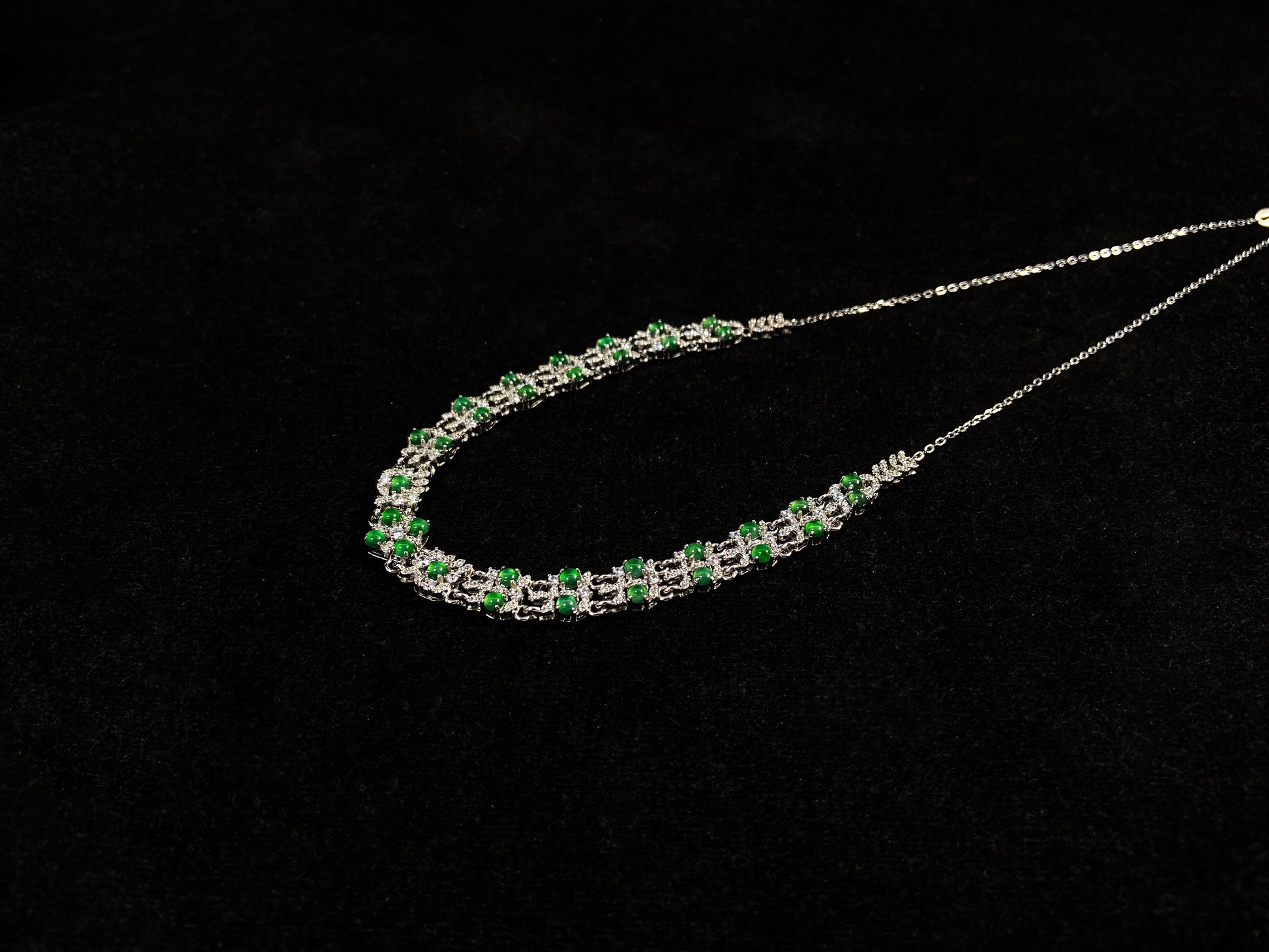 A necklace set with vibrant green jadeite cabochons.