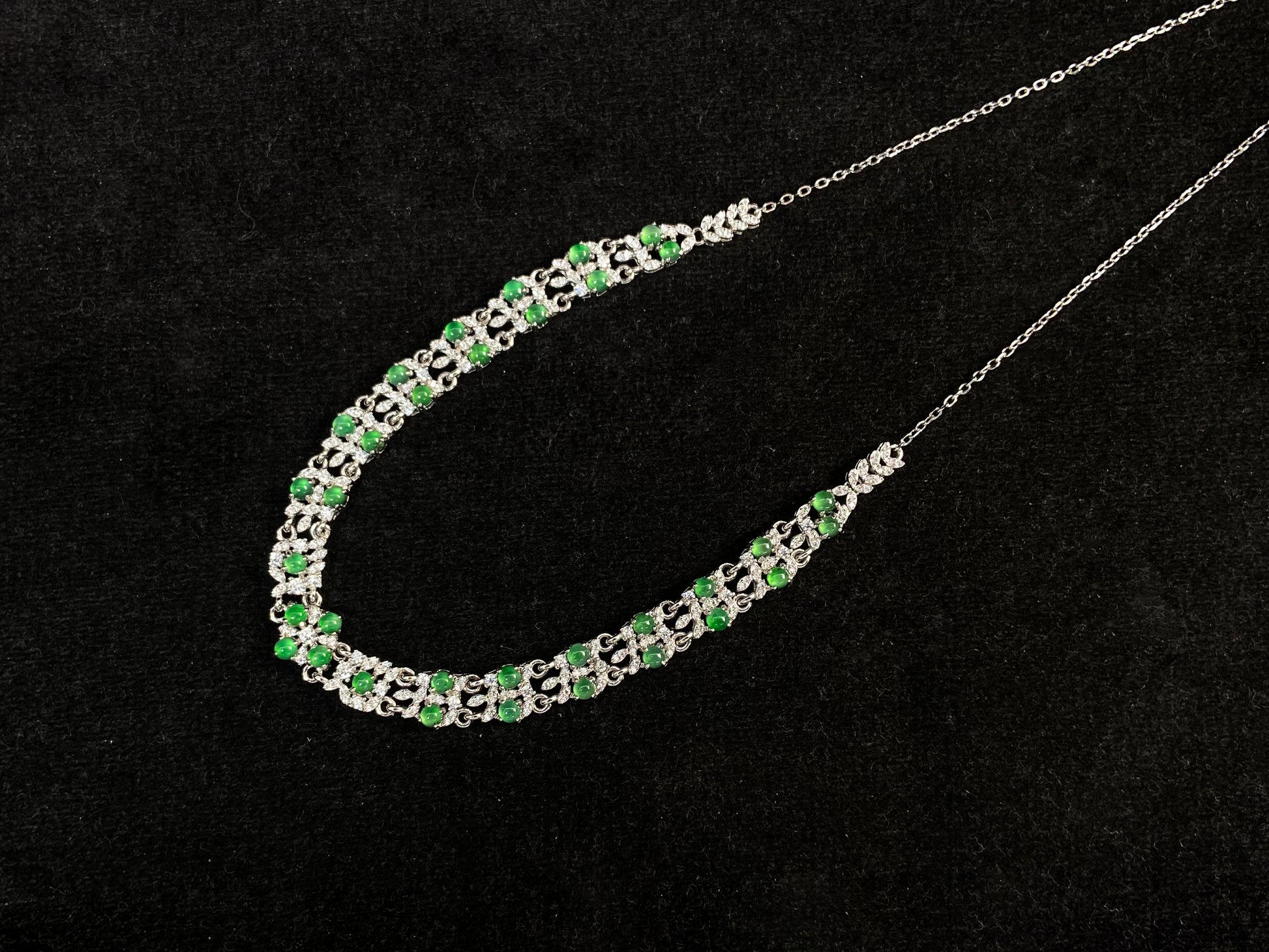 A necklace set with vibrant green jadeite cabochons.