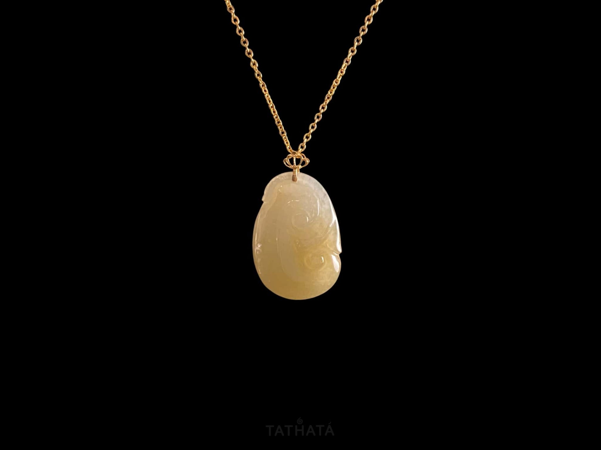 A creamy yellow Ruyi jadeite pendant.