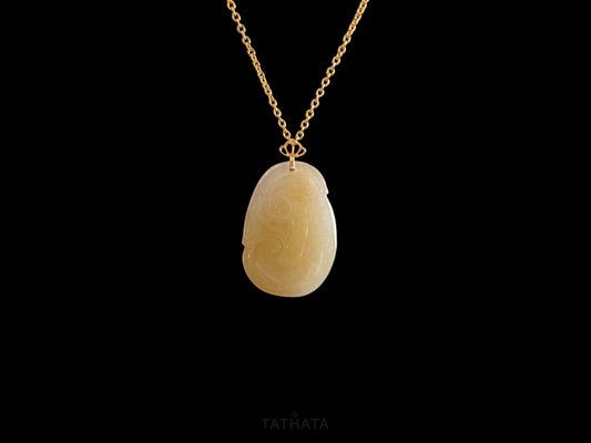 A creamy yellow Ruyi jadeite pendant.