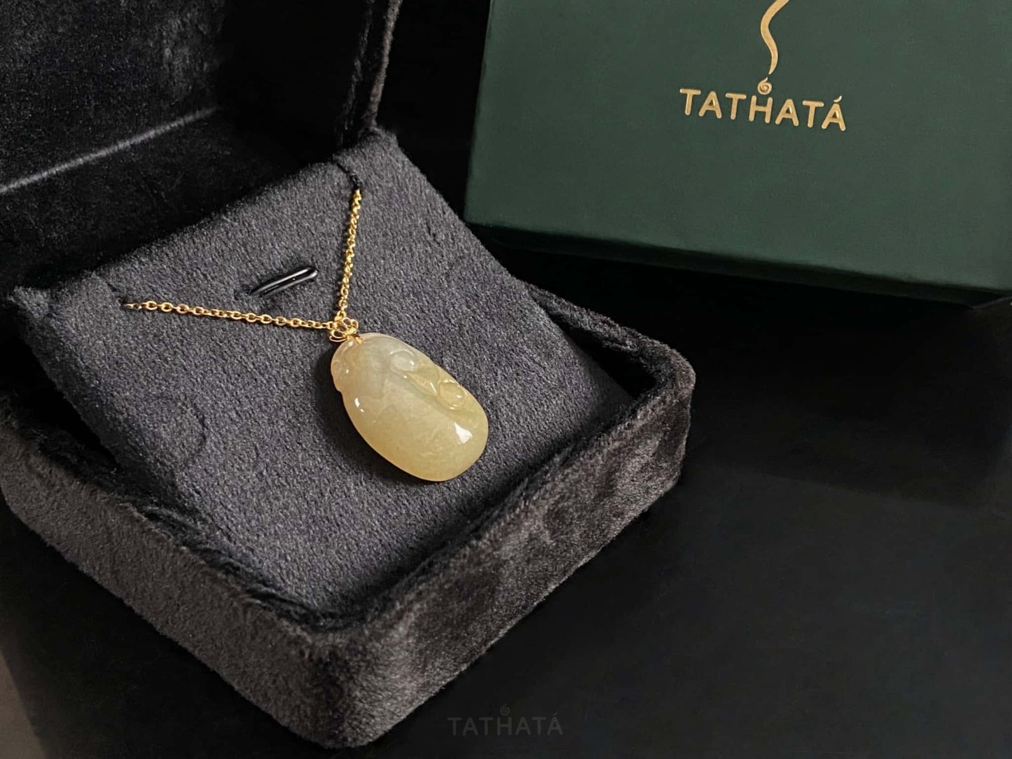 A creamy yellow Ruyi jadeite pendant.
