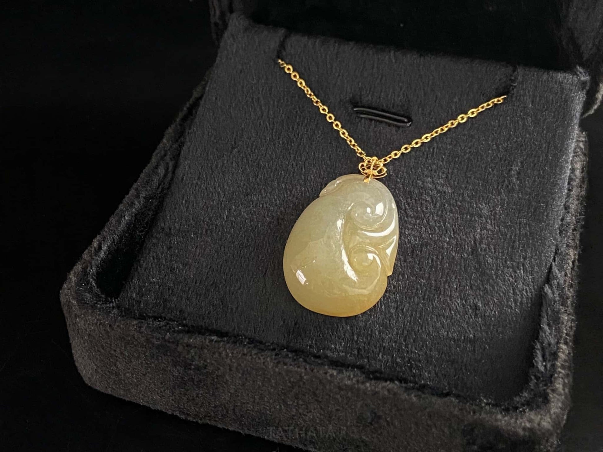 A creamy yellow Ruyi jadeite pendant.