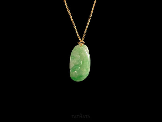 A foat green Ruyi jadeite pendant.