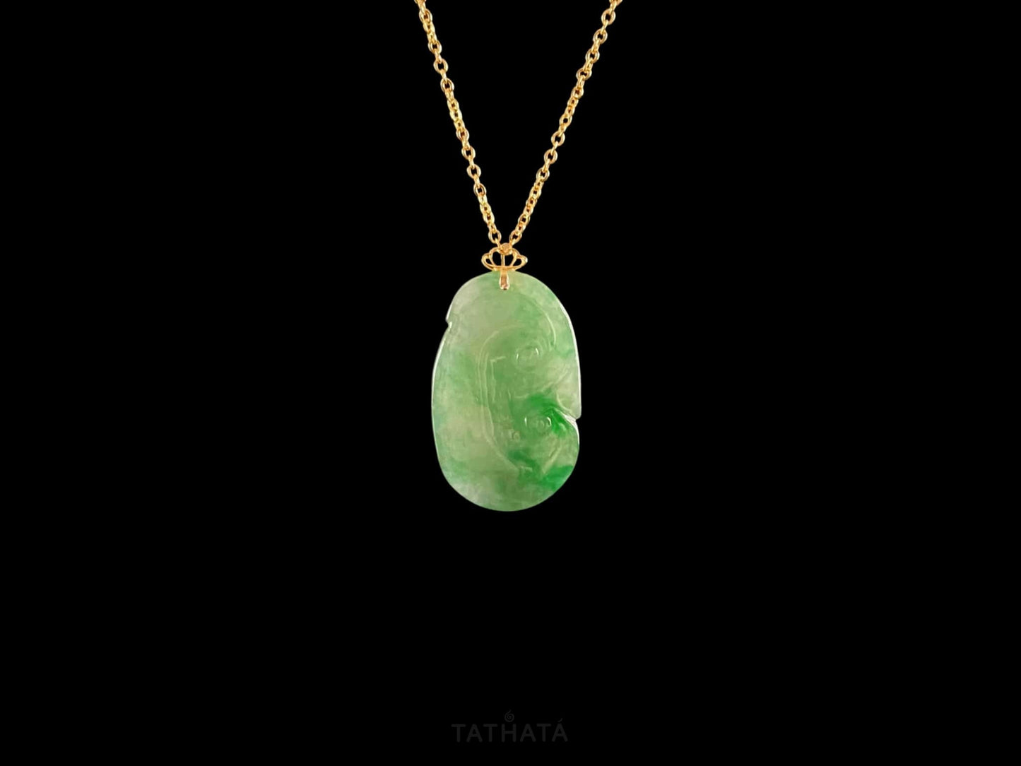 A foat green Ruyi jadeite pendant.