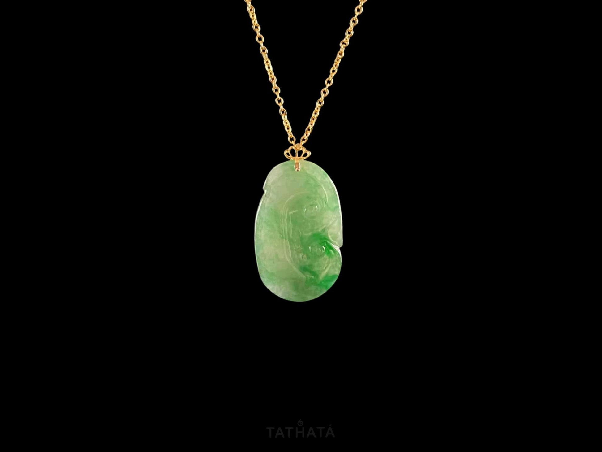 A foat green Ruyi jadeite pendant.