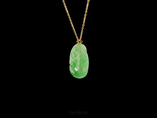 A foat green Ruyi jadeite pendant.
