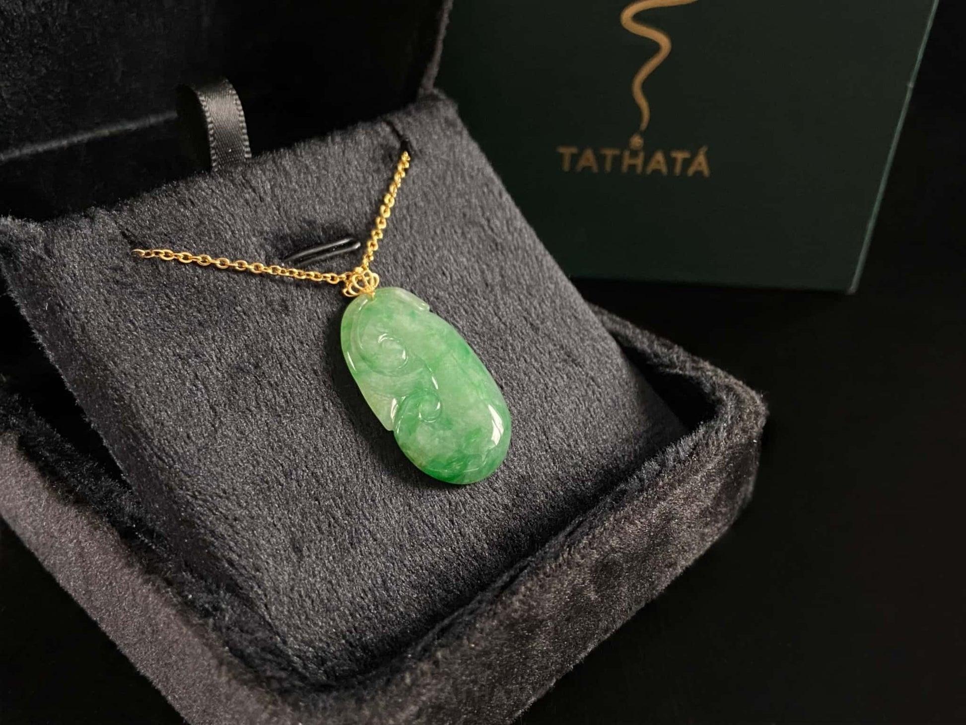 A foat green Ruyi jadeite pendant.