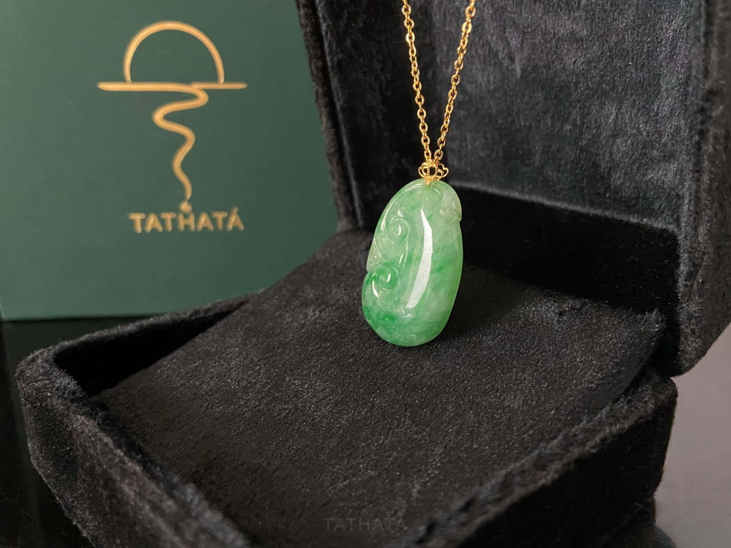 A foat green Ruyi jadeite pendant.