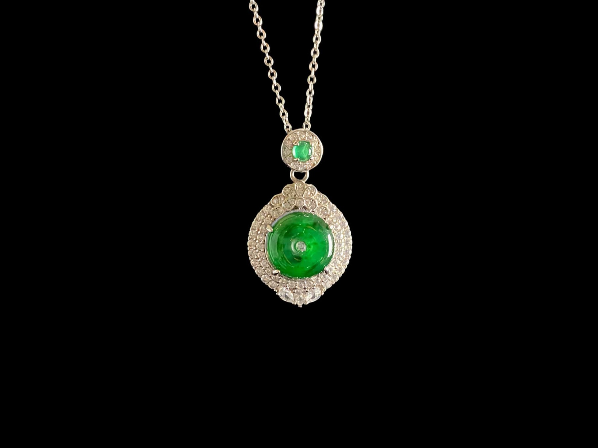 A verdant halo peace disc jadeite pendant.