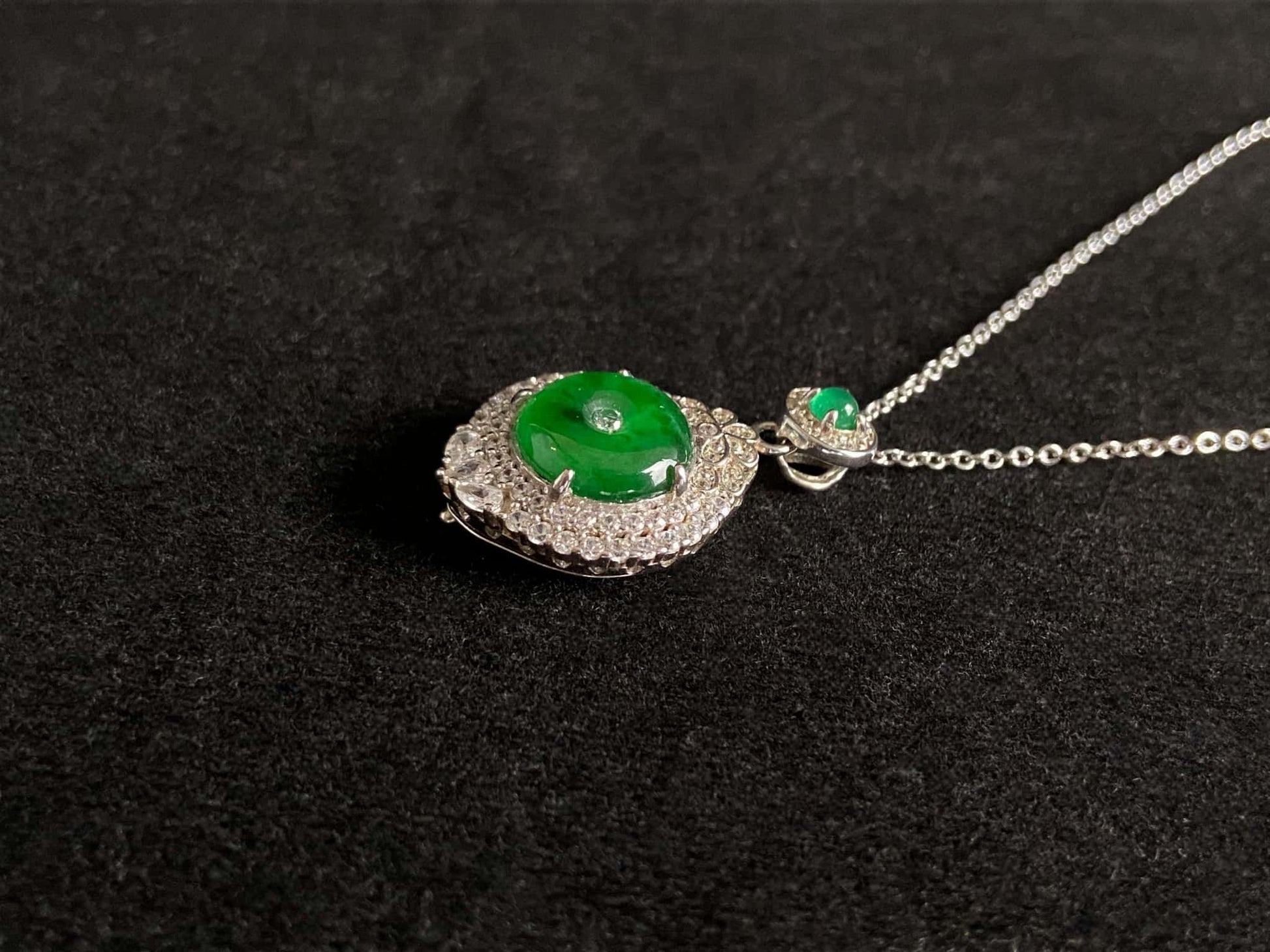 A verdant halo peace disc jadeite pendant.