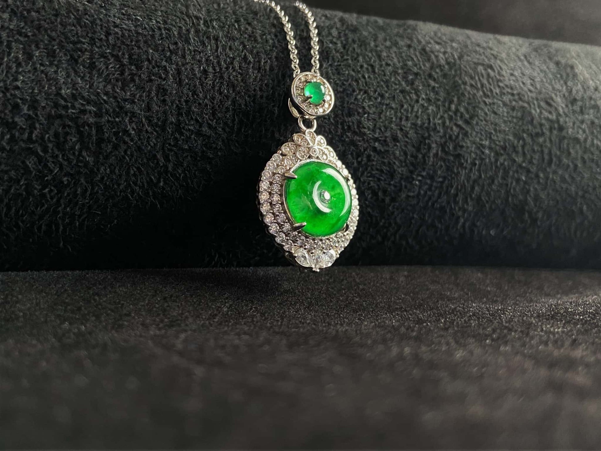 A verdant halo peace disc jadeite pendant.