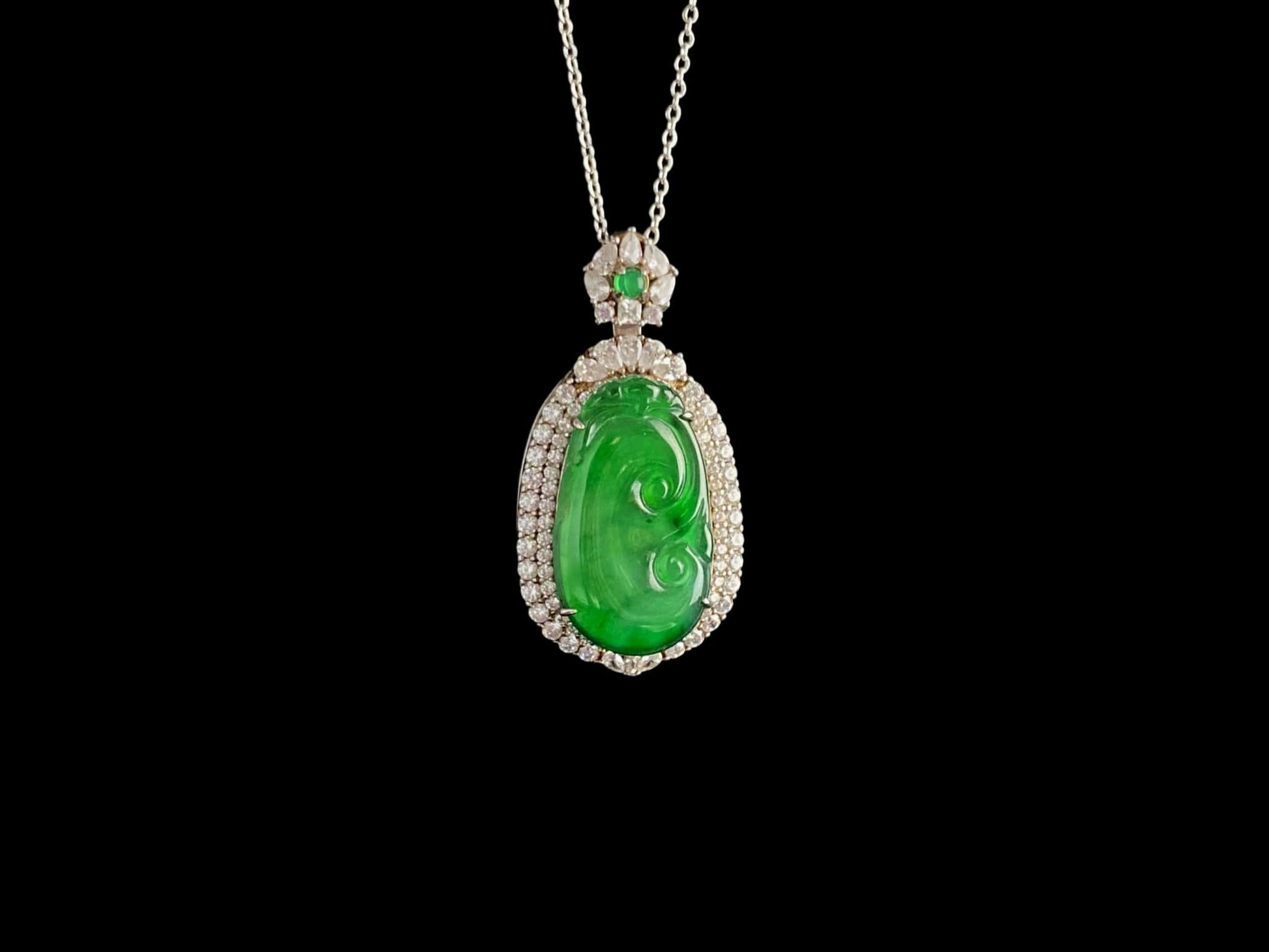A vivid green spirit Ruyi jadeite pendant.
