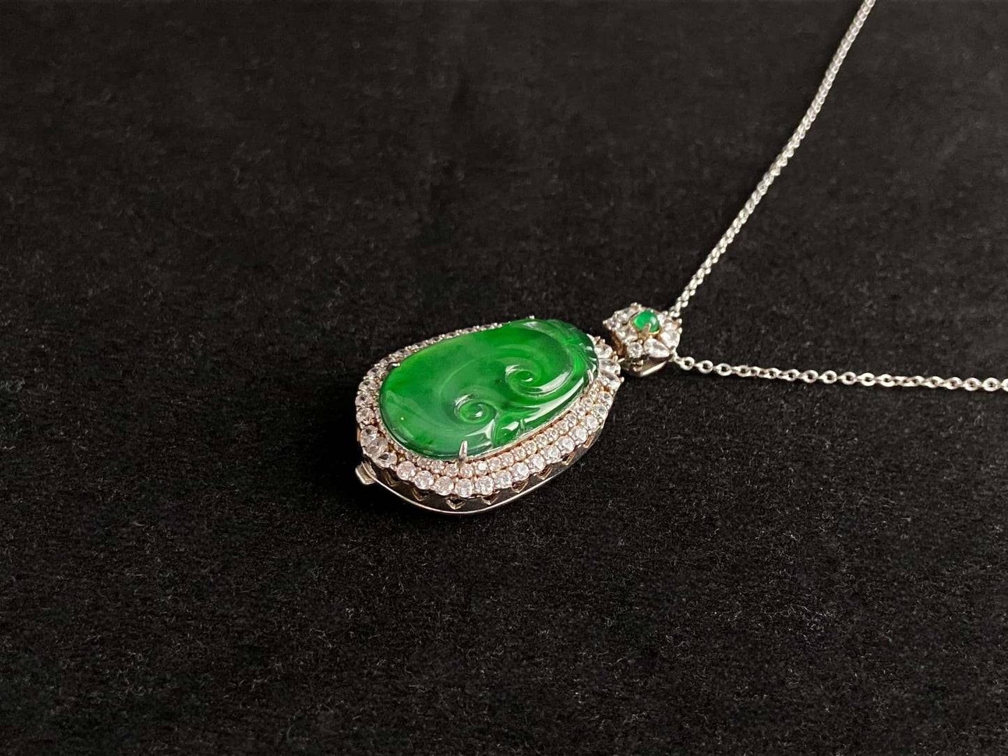 A vivid green spirit Ruyi jadeite pendant.