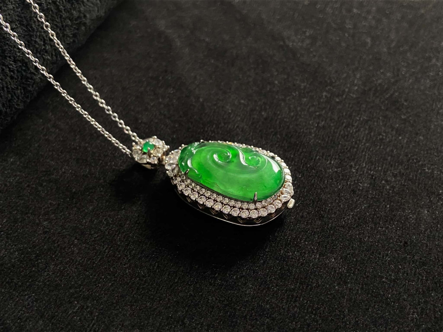 A vivid green spirit Ruyi jadeite pendant.