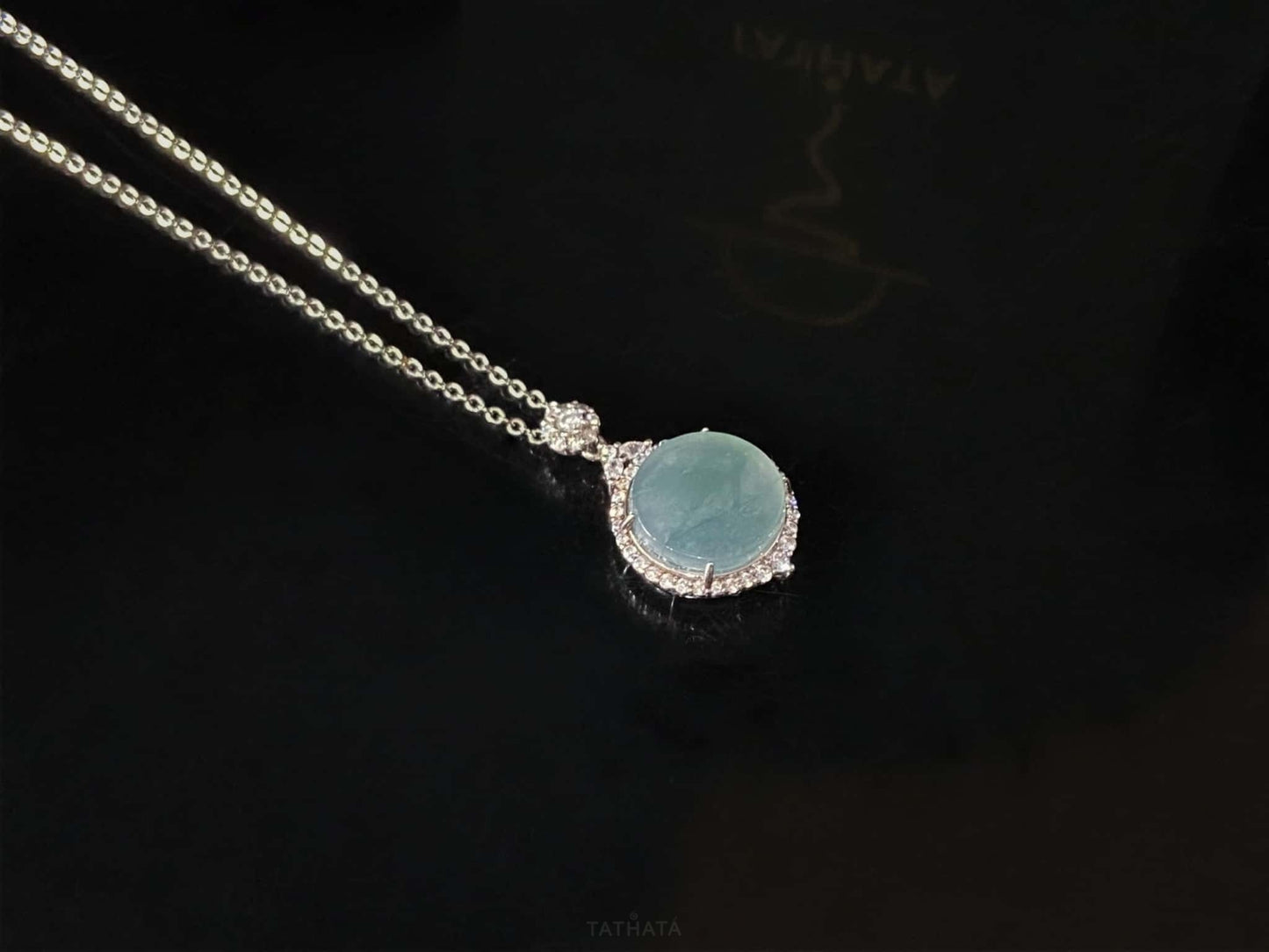 A mint dew disk jadeite pendant.