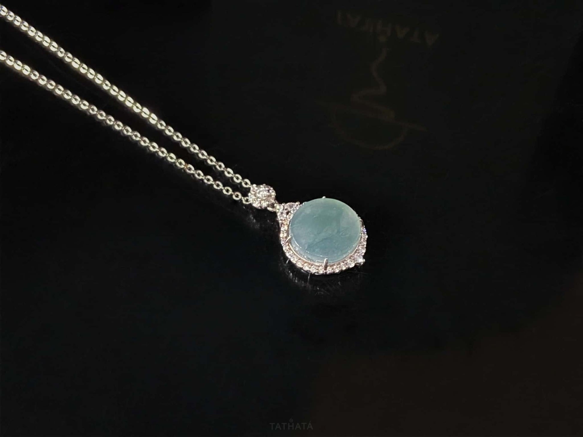 A mint dew disk jadeite pendant.
