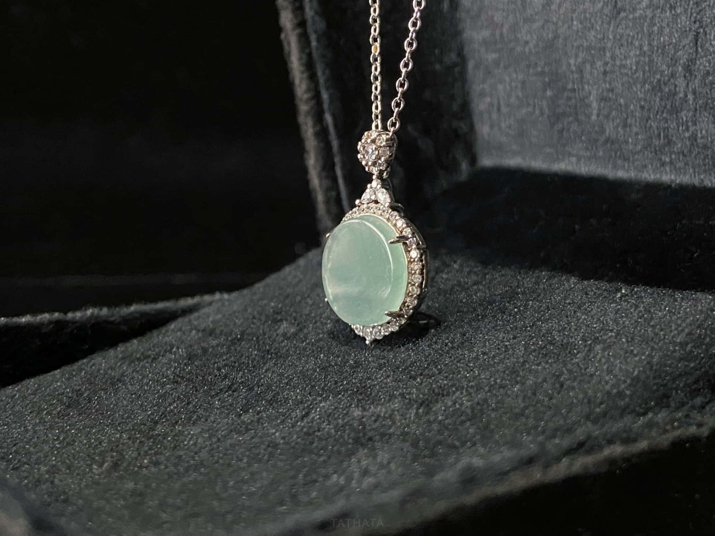 A mint dew disk jadeite pendant.