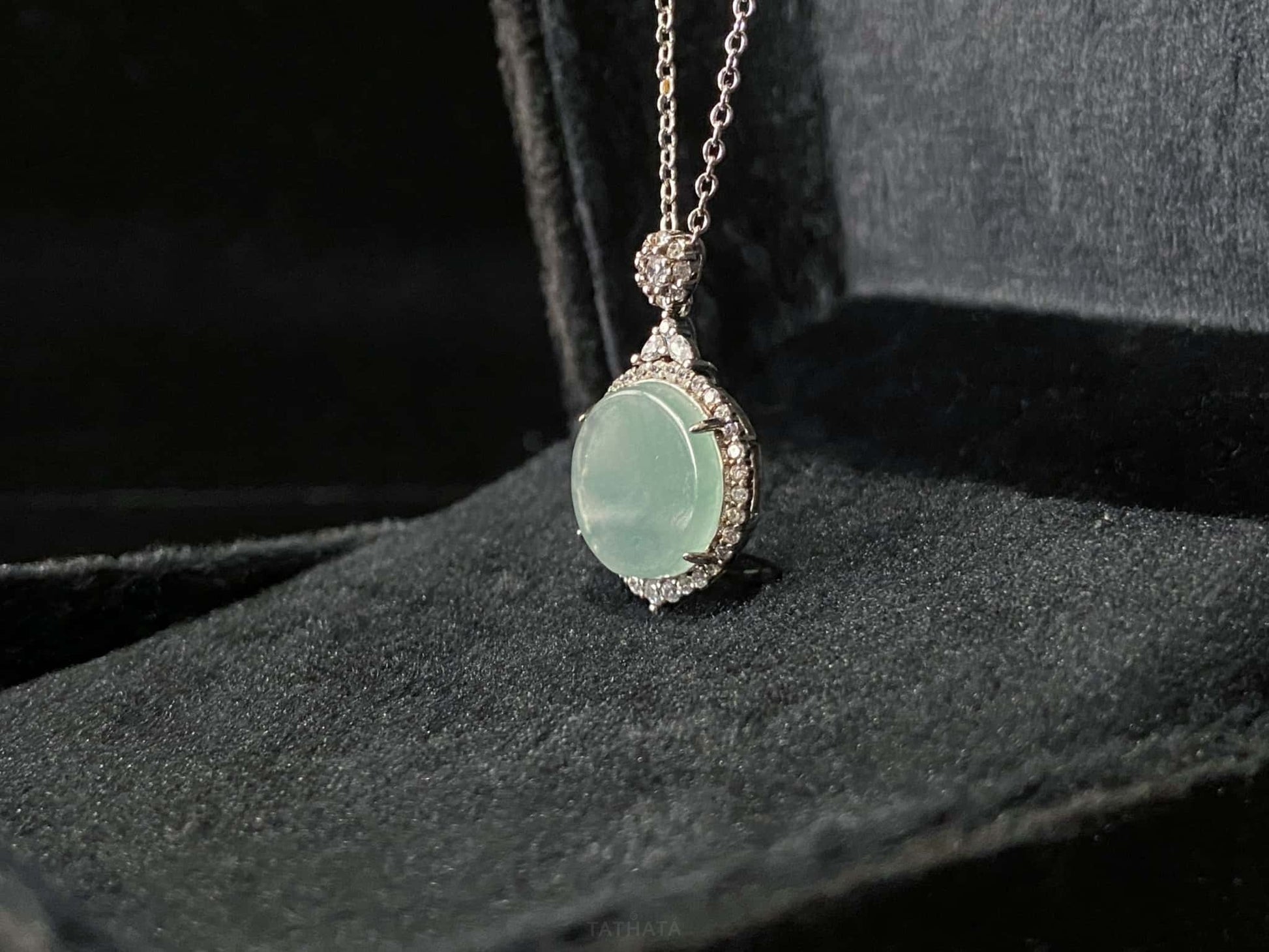 A mint dew disk jadeite pendant.