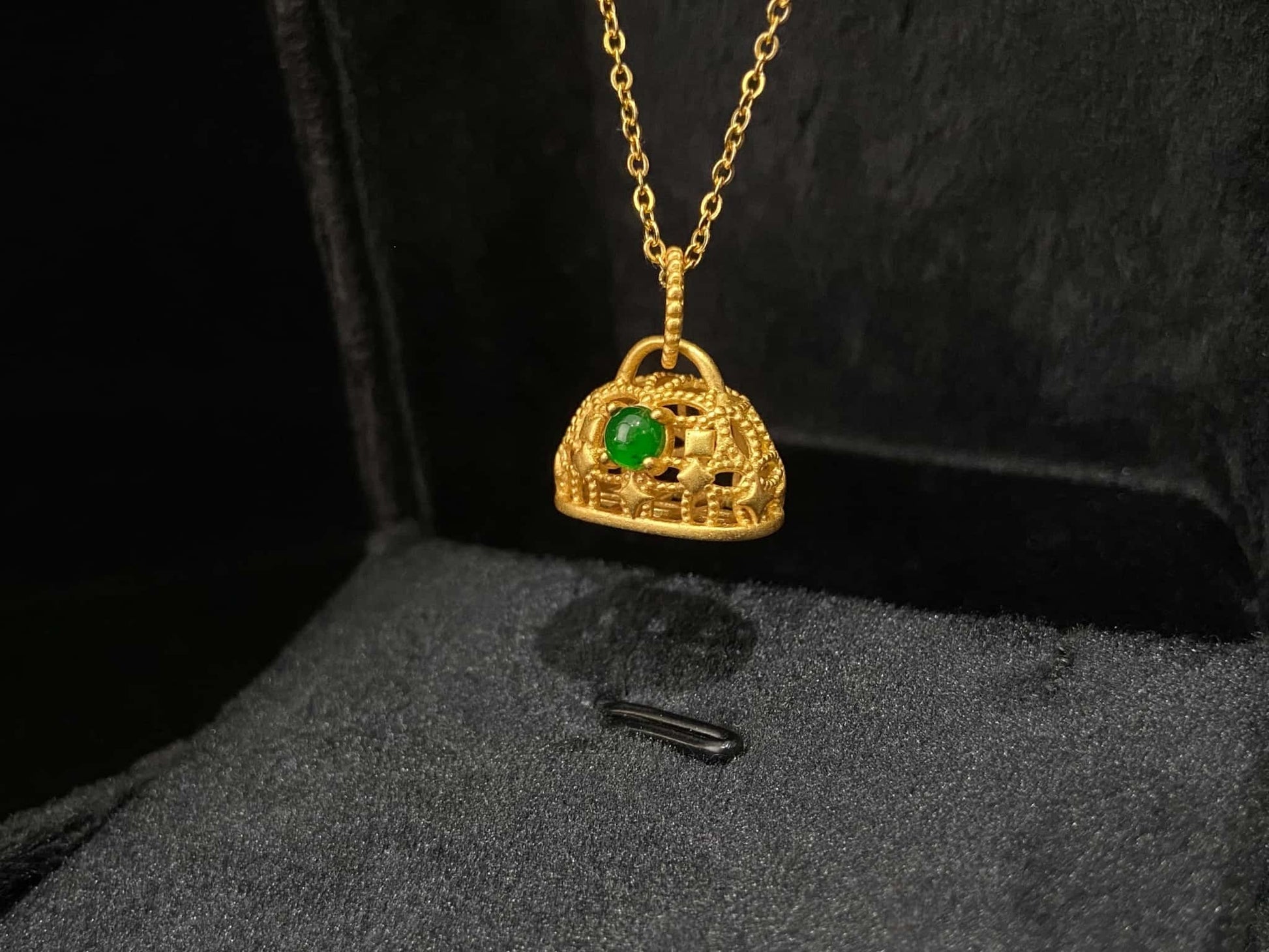 A auspicious green latch jadeite pendant.