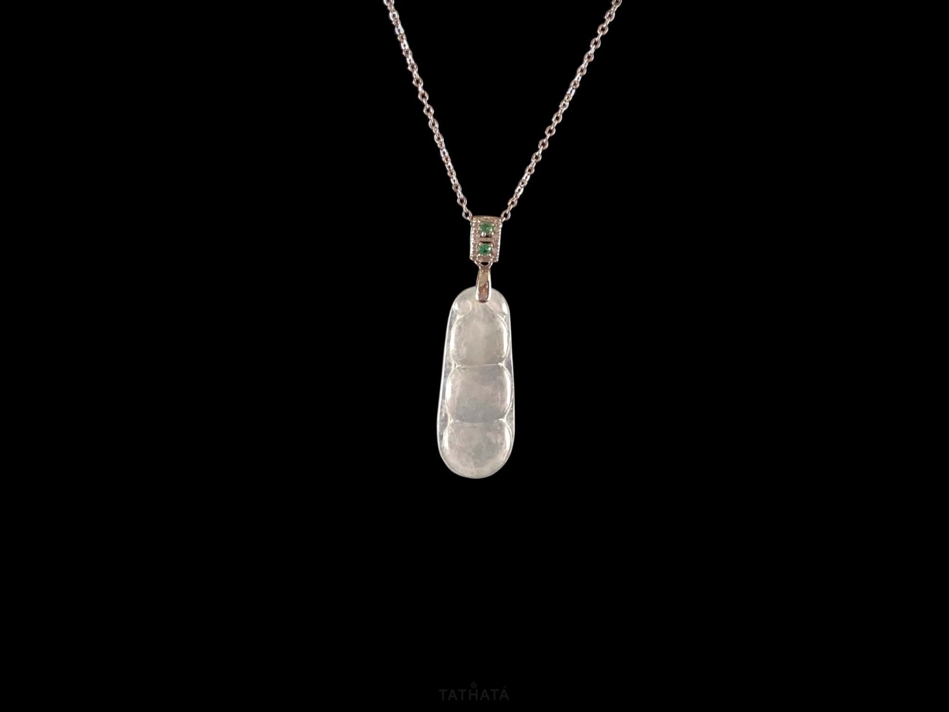 A glacial green bean jadeite pendant.