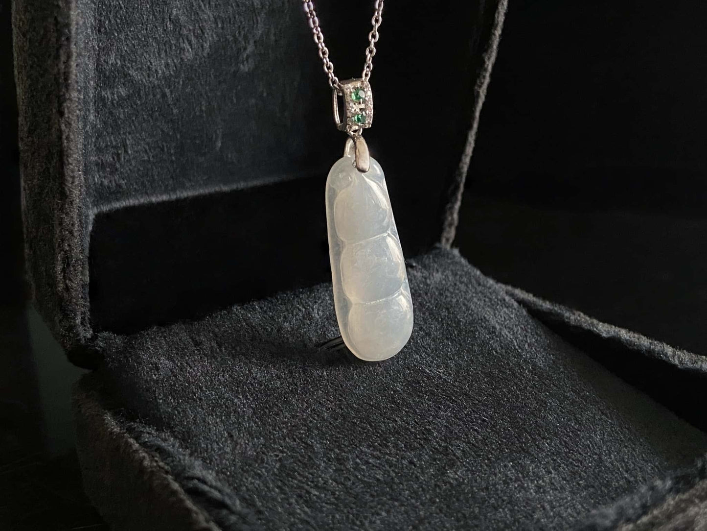 A glacial green bean jadeite pendant.