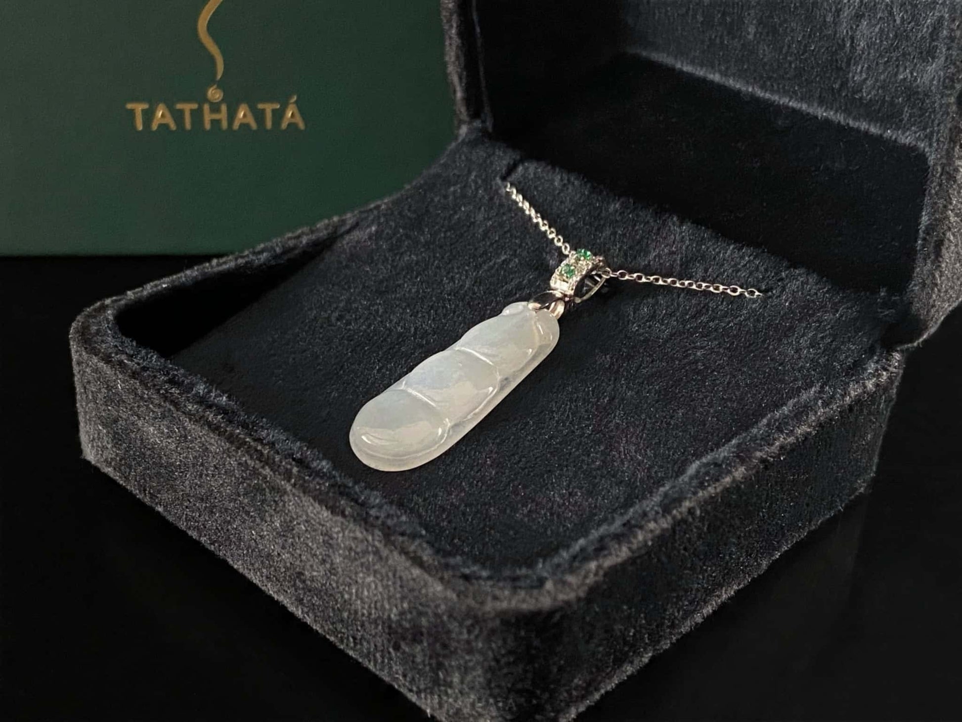 A glacial green bean jadeite pendant.