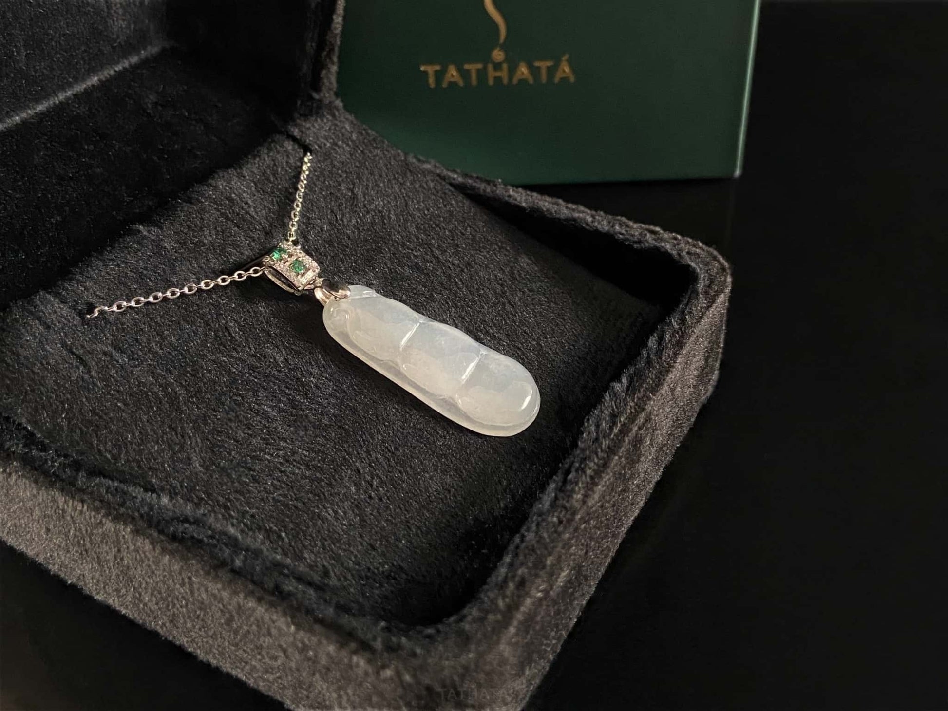 A glacial green bean jadeite pendant.