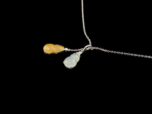 A sun and moon twin gourds jadeite pendant.
