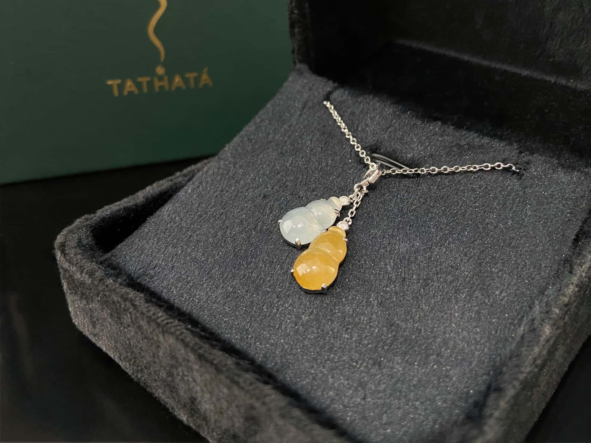 A sun and moon twin gourds jadeite pendant.