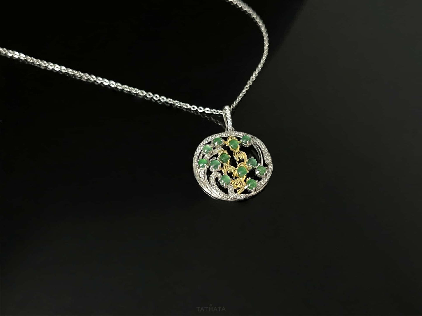 A green koi wreath jadeite pendant.