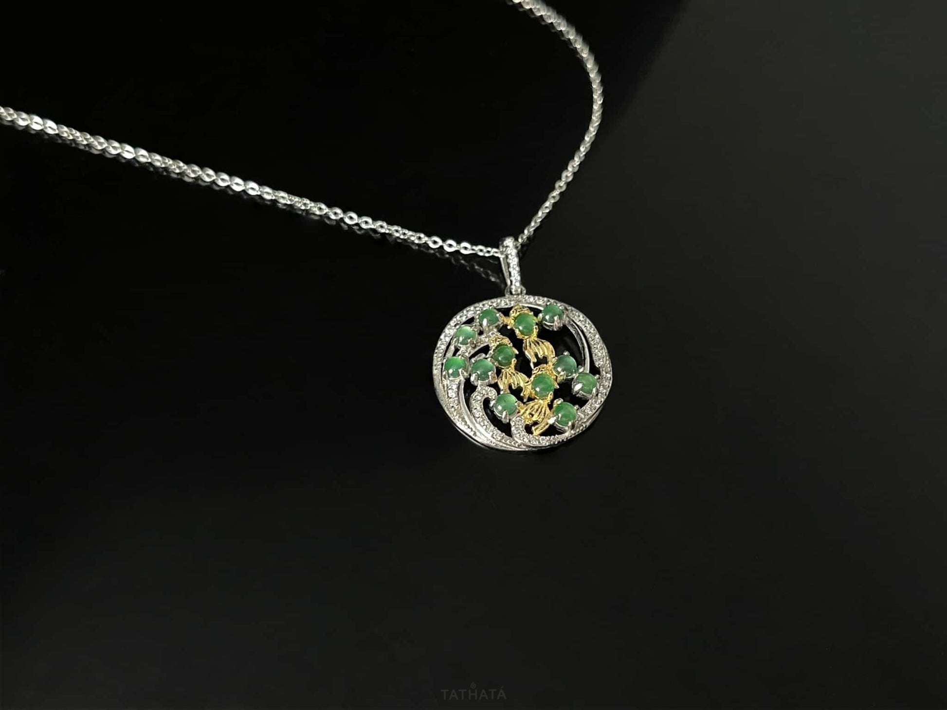 A green koi wreath jadeite pendant.