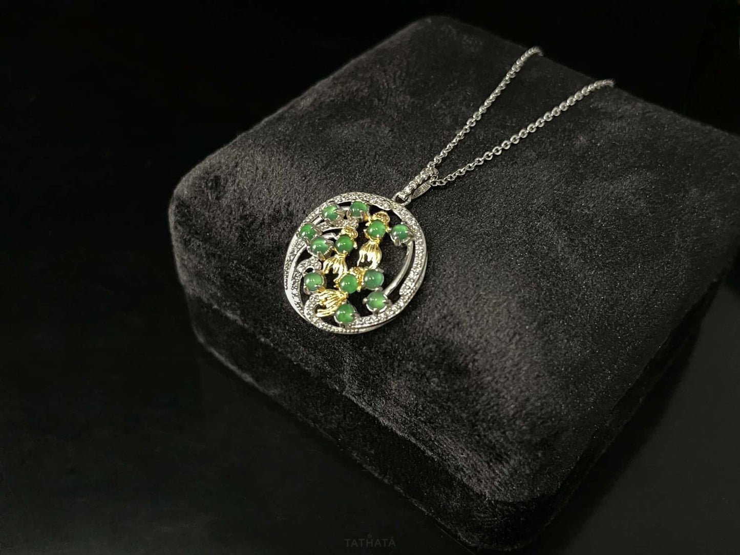 A green koi wreath jadeite pendant.