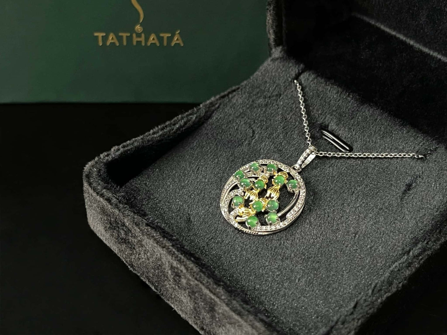 A green koi wreath jadeite pendant.