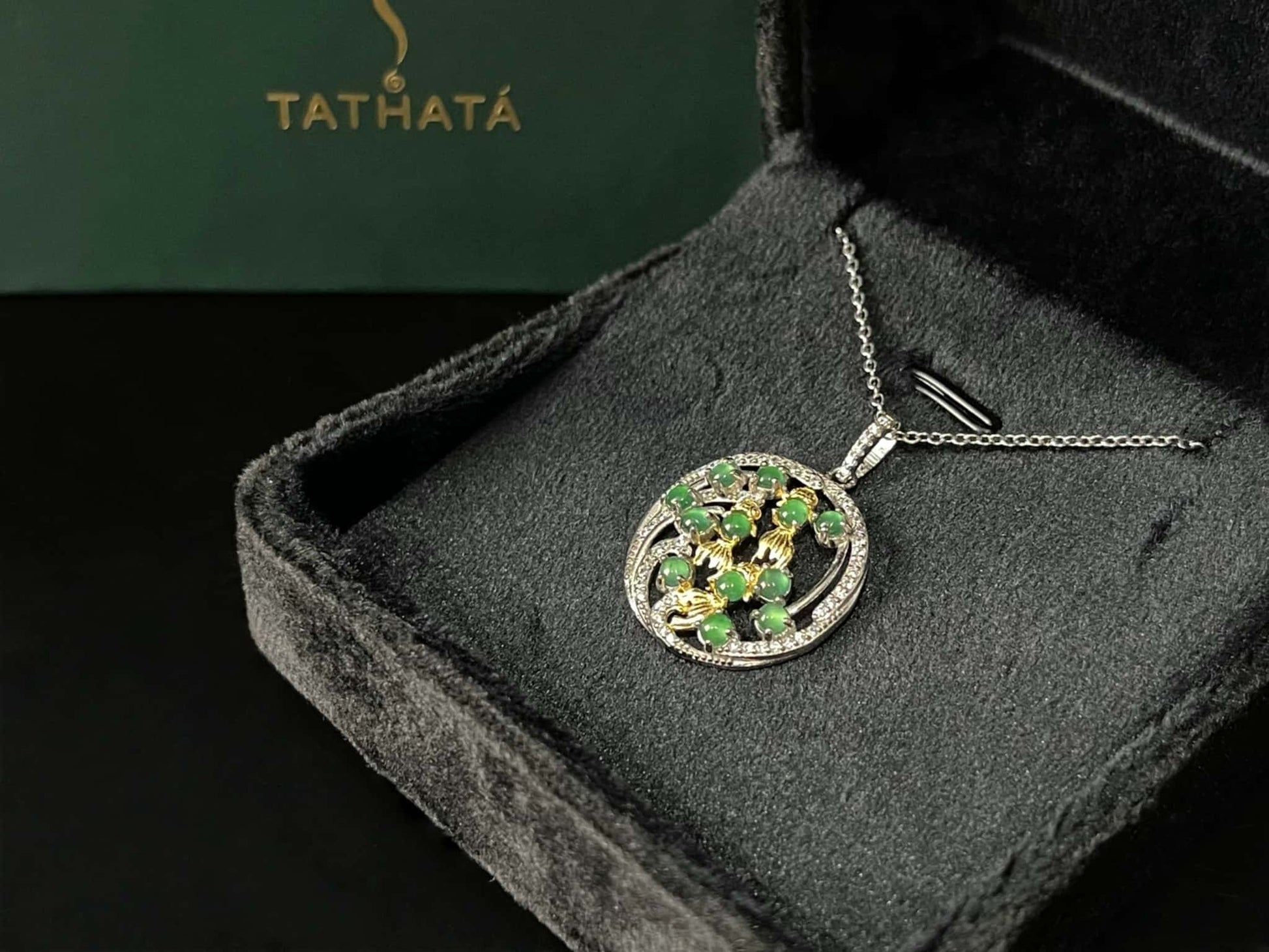 A green koi wreath jadeite pendant.
