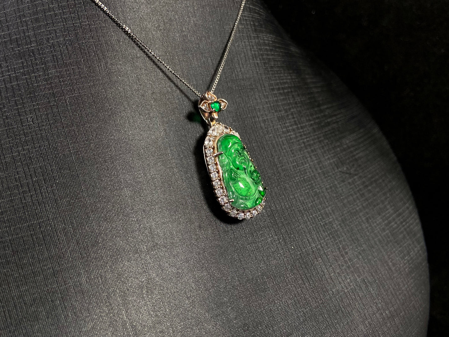 A green jade pendant depicting the God of Wealth, elegantly framed in 925 sterling silver.