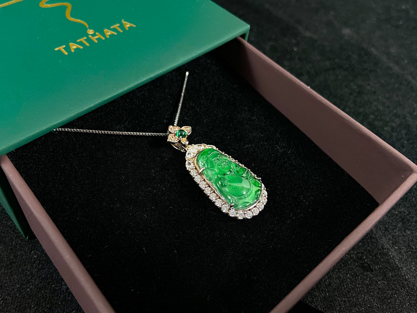 A green jade pendant depicting the God of Wealth, elegantly framed in 925 sterling silver.