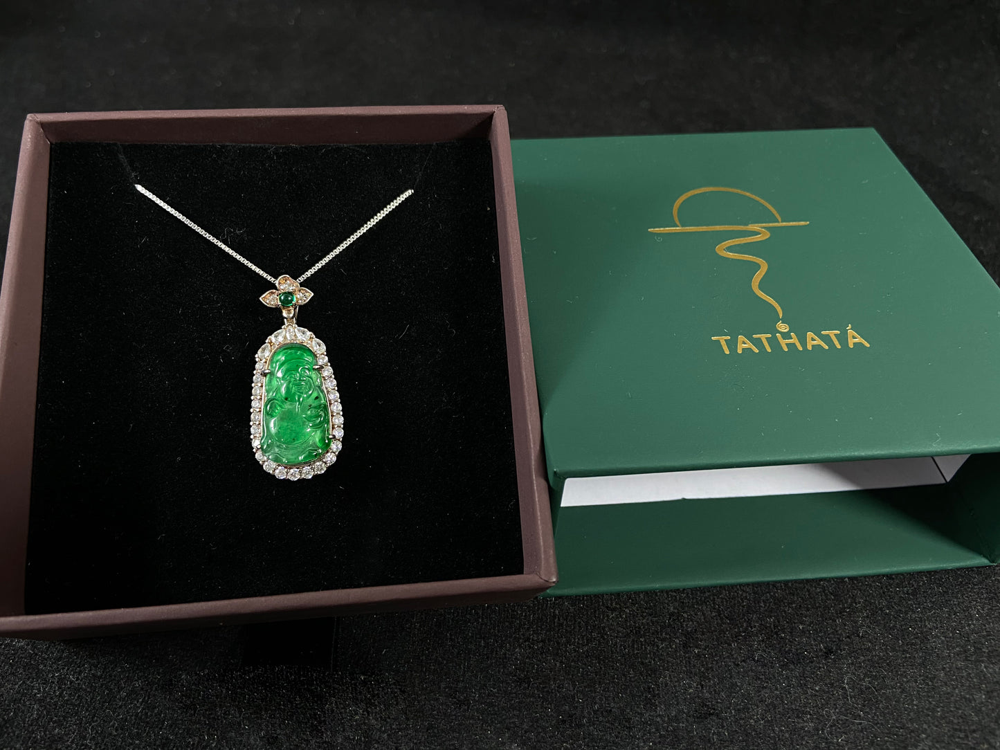 A green jade pendant depicting the God of Wealth, elegantly framed in 925 sterling silver.