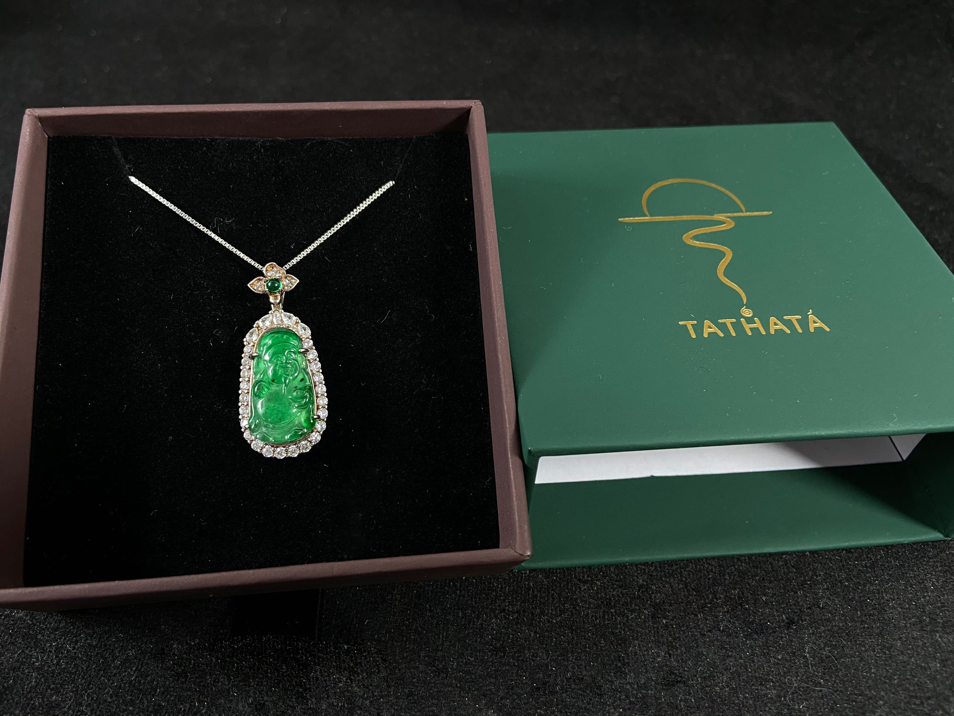 A green jade pendant depicting the God of Wealth, elegantly framed in 925 sterling silver.