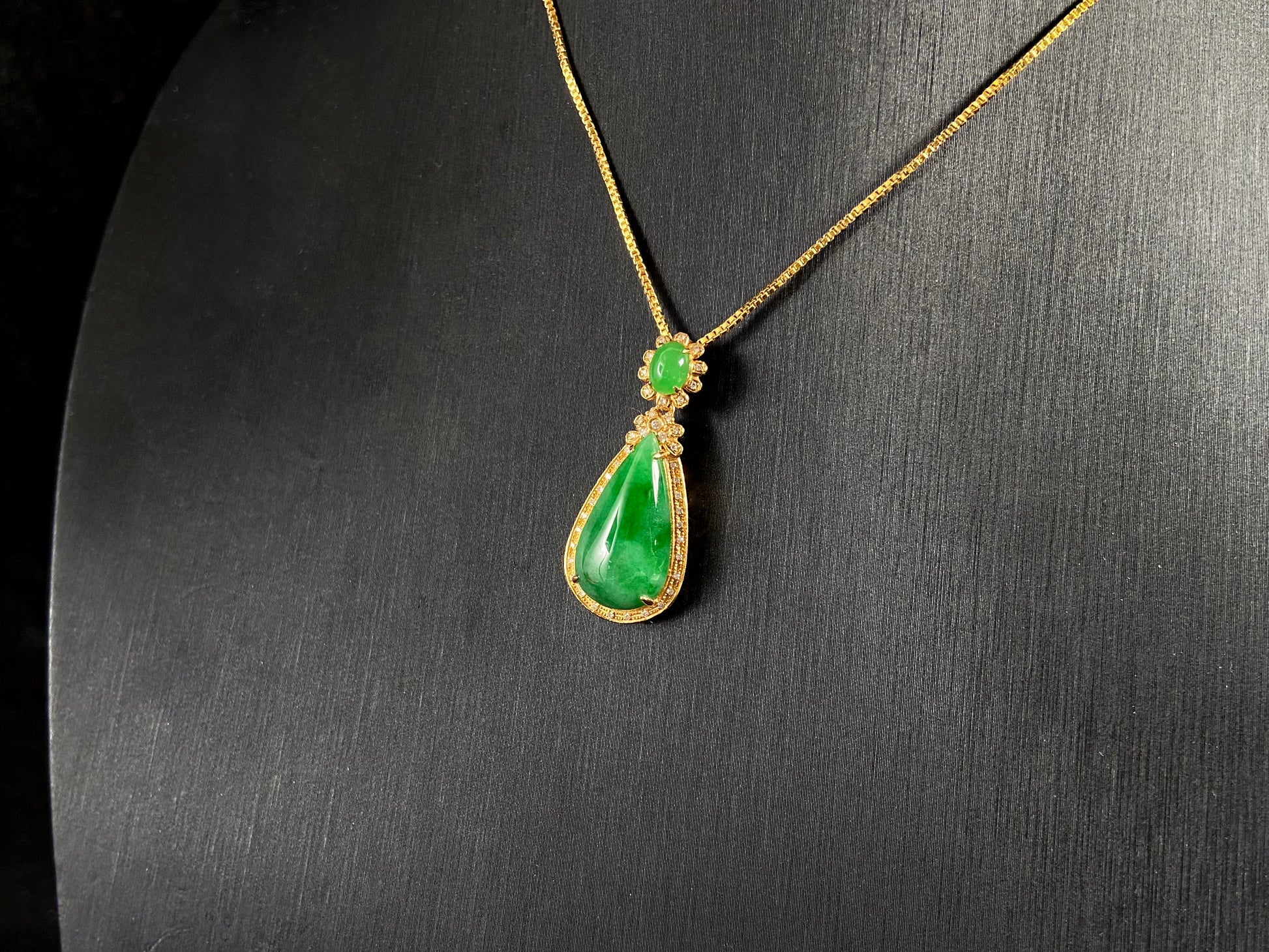Imperial Jadeite meets sterling silver in this elegant pendant, masterfully uniting an oval and teardrop in one harmonious design.