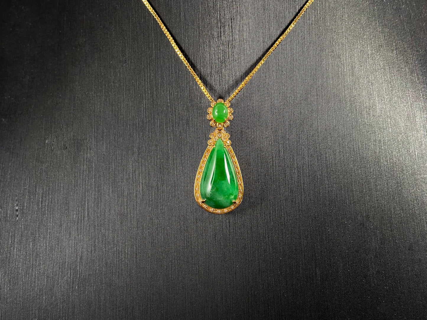 Imperial Jadeite meets sterling silver in this elegant pendant, masterfully uniting an oval and teardrop in one harmonious design.