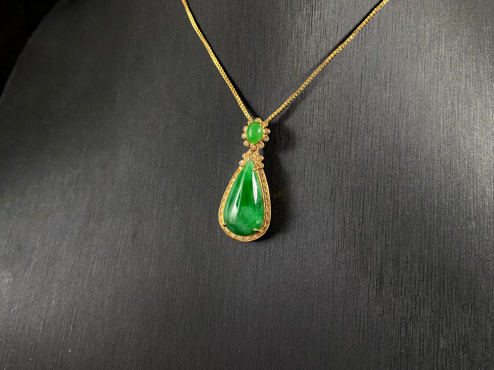 Imperial Jadeite meets sterling silver in this elegant pendant, masterfully uniting an oval and teardrop in one harmonious design.