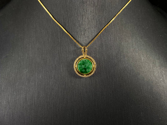 This pendant centers a small, round jadeite with a translucent white base and wisps of green, framed by a wide band of 925 silver.