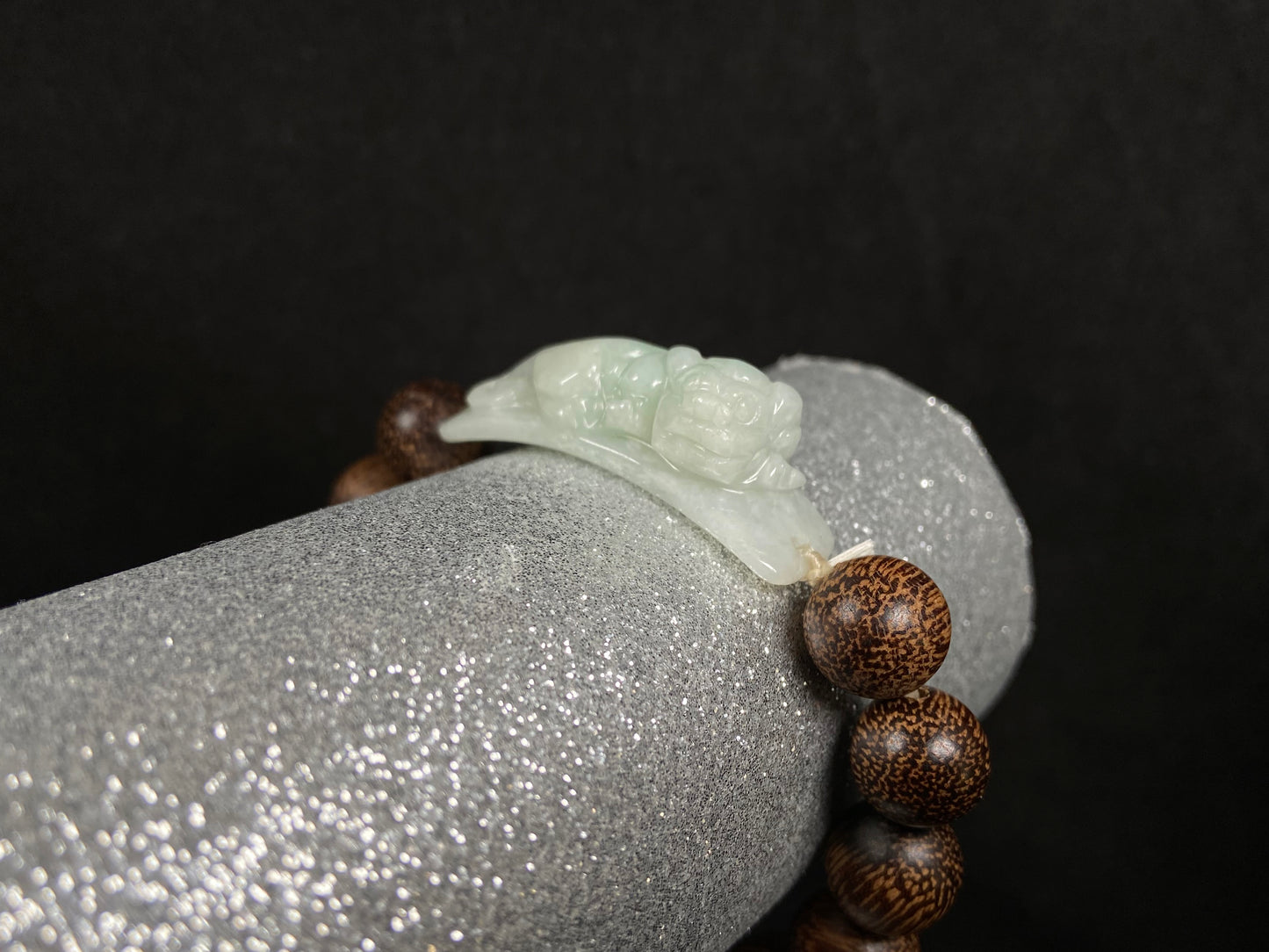 A white green Pixiu’s blessing jadeite agarwood bracelet.