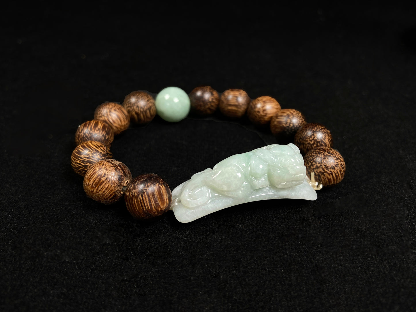 A white green Pixiu’s blessing jadeite agarwood bracelet.