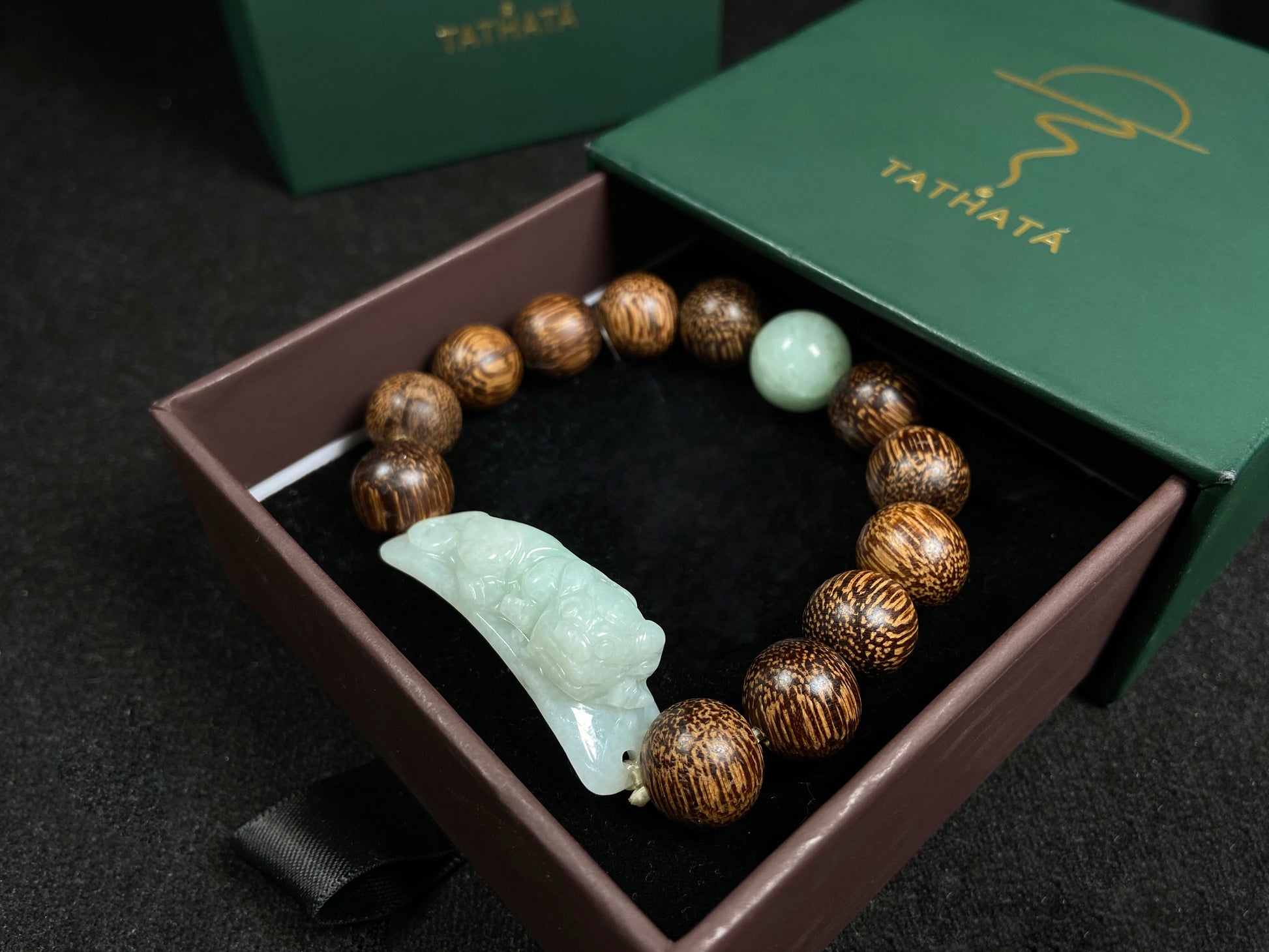 A white green Pixiu’s blessing jadeite agarwood bracelet.