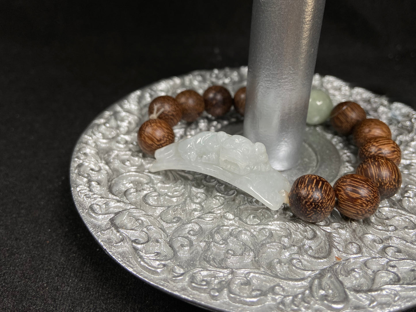 A white green Pixiu’s blessing jadeite agarwood bracelet.