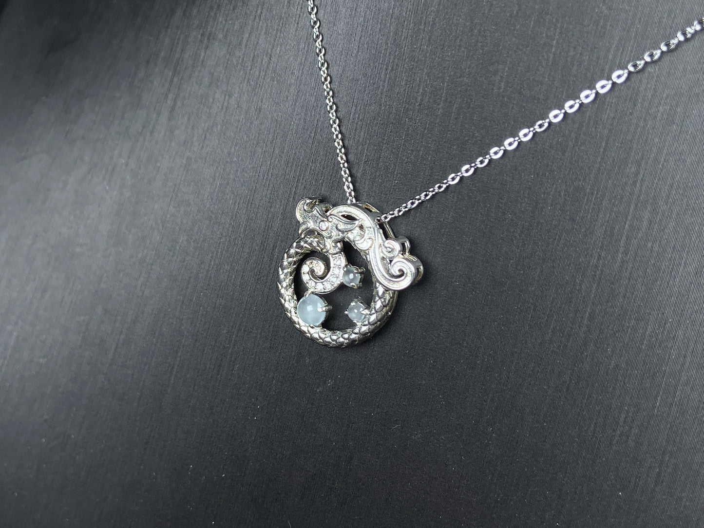 A icy blue coiled dragon jadeite pendant.