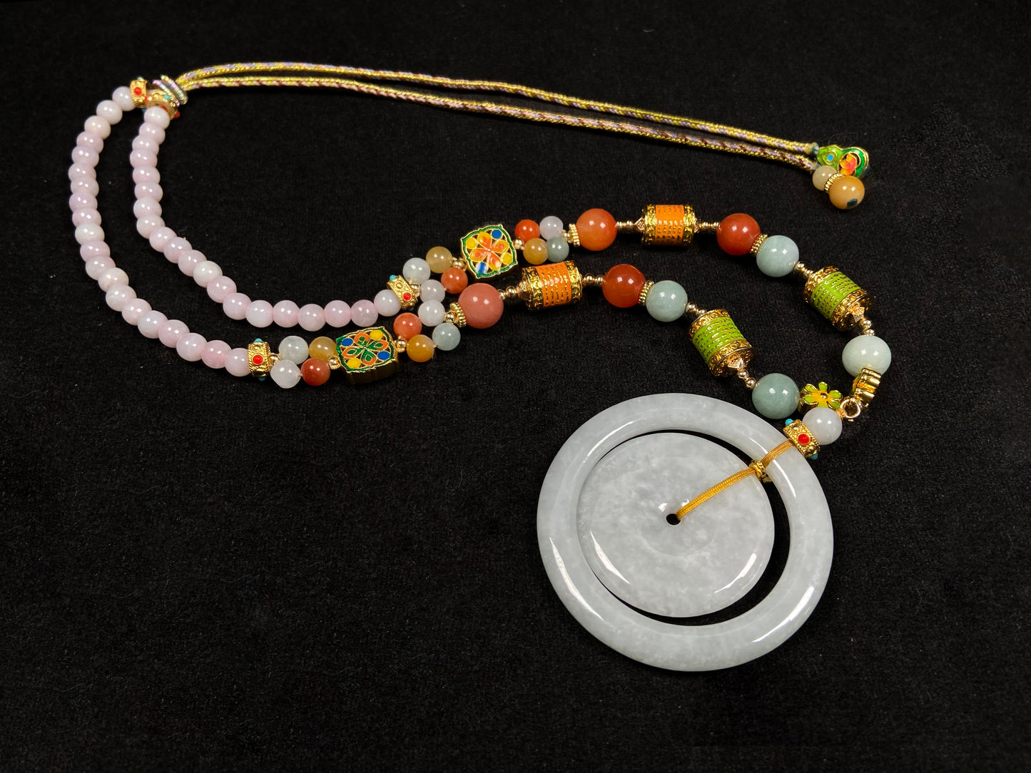 A sleek pale white double ring peace buckle jadeite pendant.